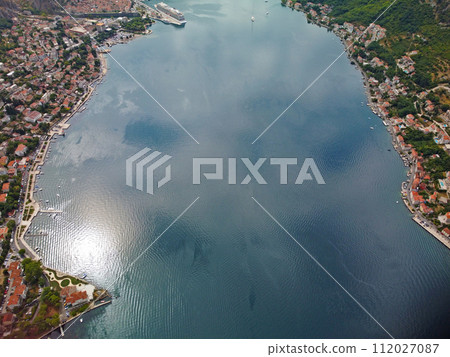 Aerial drone high view of Kotor bay, Boka Kotorska and coastal town Kotor, Cattaro, in Montenegro. Location place famous resort Montenegro. Adriatic fjord surrounded by rugged mountains Aerial drone high view of Kotor bay, Boka Kotorska and coastal town Kotor, Cattaro, in Montenegro. Location place famous resort Montenegro. Adriatic fjord surrounded by rugged mountains 112027087