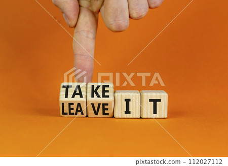 Take or leave it symbol. Businessman turns beautiful wooden cubes and changes words Leave it to Take it. Beautiful orange table orange background. Copy space. Business and take or leave it concept. 112027112