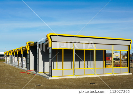 Unfinished large modern self clean coin operated car wash service station, vehicle cleaning station 112027265