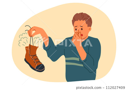 Smelly shoe in hands of man suffering from bad odor and symptoms of foot mycosis Smelly shoe in hands of man suffering from bad odor and symptoms of foot mycosis 112027409