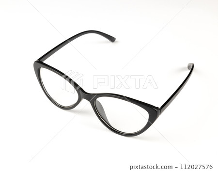 Black plastic glasses on a white background. The concept of ophthalmology. Black plastic glasses on a white background. The concept of ophthalmology. 112027576