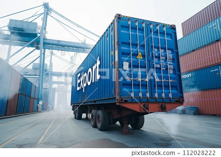 Container with Export on trailer in shipping yard with cranes and ships 112028222