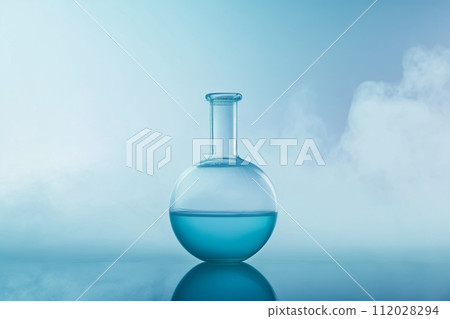 A single round flask with blue liquid emits wisps of vapor on a reflective surface 112028294