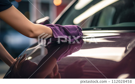 Hand with microfiber cloth polishing car Hand with microfiber cloth polishing car 112028458