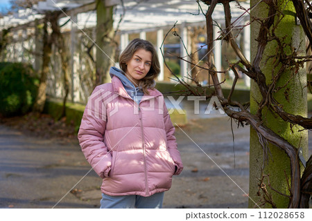 Young beautiful pretty tourist girl in warm hat and coat with backpack walking at cold autumn in Europe city enjoying her travel in Bietigheim-Bissingen, Deutschland. Outdoor portrait of young tourist Young beautiful pretty tourist girl in warm hat and coat with backpack walking at cold autumn in Europe city enjoying her travel in Bietigheim-Bissingen, Deutschland. Outdoor portrait of young tourist 112028658