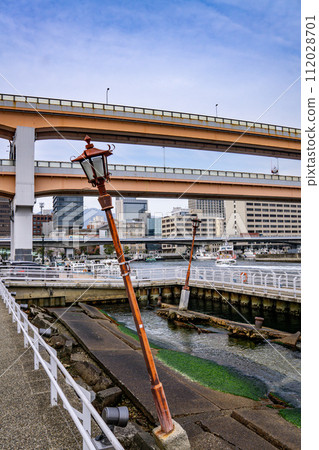 Kobe, Japan - city in the region of Kansai in Hyogo prefecture. Earthquake memorial preserving ruined pier. 112028701