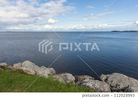 Natural landscape photo taken at the coast of a lake. Coastal rocks 112028993