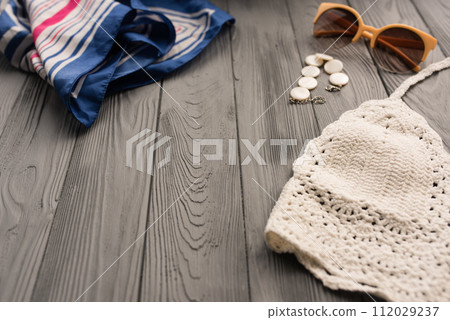 white knitted top woman trending two-piece swimsuit beach swimwear fashion sunglasses. Summer background 112029237