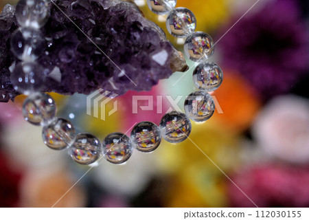 Power stone amethyst and crystal bracelet colorful background Power stone amethyst and crystal bracelet colorful background 112030155