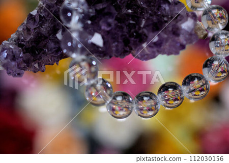 Power stone amethyst and crystal bracelet colorful background Power stone amethyst and crystal bracelet colorful background 112030156