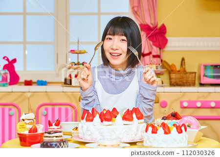 A young woman surrounded by sweets 112030326