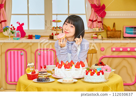 young woman holding a donut 112030637