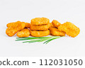 Chicken Breaded Fillet. Breaded chicken nuggets. Fast homemade food at home. Chicken breaded schnitzels. Breaded Chicken Inner Fillet on a White Background,Chicken Breaded Raw Meat. Fast cooking. 112031050