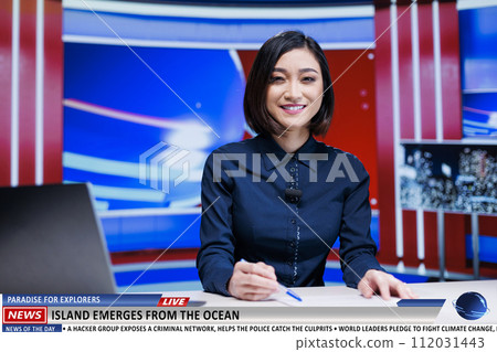 Asian reporter presents new island appearance on television show, rare natural events occured on ocean shoreline. Woman presenter talks about new exploration region for nature lovers. Asian reporter presents new island appearance on television show, rare natural events occured on ocean shoreline. Woman presenter talks about new exploration region for nature lovers. 112031443