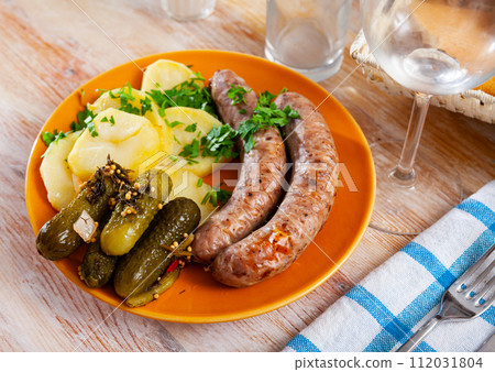Roasted sausages with homestyle boiled potatoes and pickles Roasted sausages with homestyle boiled potatoes and pickles 112031804