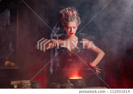 Halloween Witch with cauldron. Beautiful young Halloween Witch with cauldron. Beautiful young 112031814