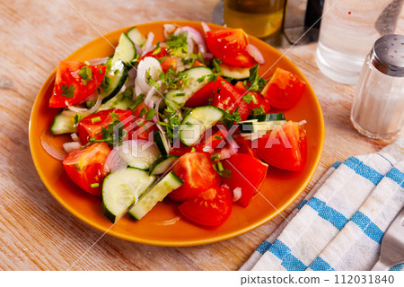 Salad from fresh tomatoes, cucumbers, red onion, parsley 112031840
