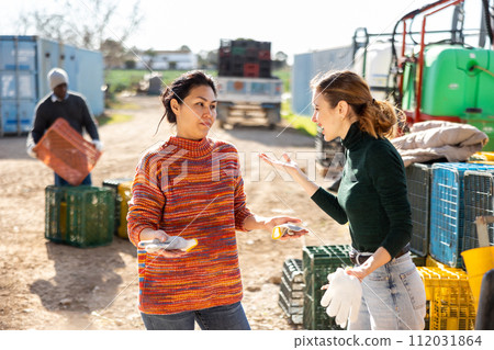 Displeased young female farmer reprimanding asian workwoman Displeased young female farmer reprimanding asian workwoman 112031864