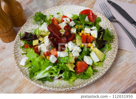 Fresh vegetable salad with mozzarella and sausages Fresh vegetable salad with mozzarella and sausages 112031950