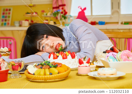 young woman eating strawberry young woman eating strawberry 112032110