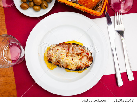 Grilled stuffed eggplant with slices of baked potato Grilled stuffed eggplant with slices of baked potato 112032148