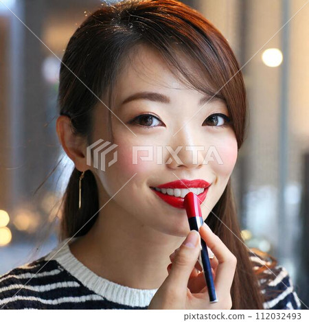 A woman applying lipstick 112032493