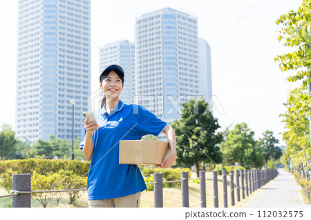 Young female courier staff carrying luggage Young female courier staff carrying luggage 112032575