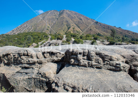 View of Batok volcano with the mystery face carved into rock in Bromo Tengger Semeru National Park, East Java, Indonesia. 112033346
