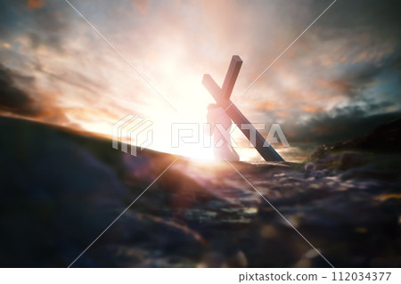 Calvary Golgotha Hill red sky, bright light and Jesus carrying the cross symbolizing pain and trials, death and resurrection, Passion Week background 112034377