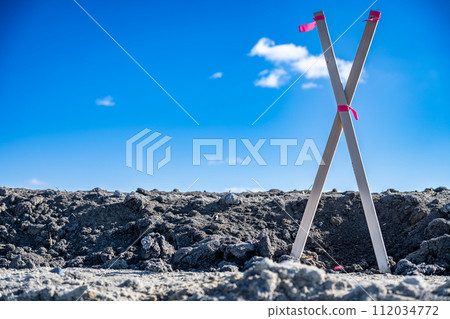 Selective focus on survey stake and flag at a construction site 112034772