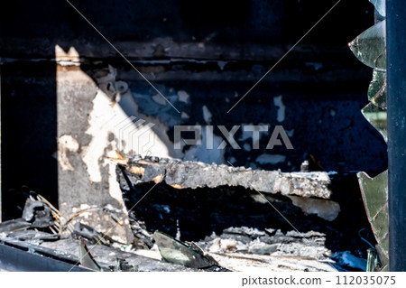 broken glass from shattered door and window caused by a fire. 112035075