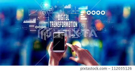 Digital Transformation concept with person using a smartphone at night Digital Transformation concept with person using a smartphone at night 112035126