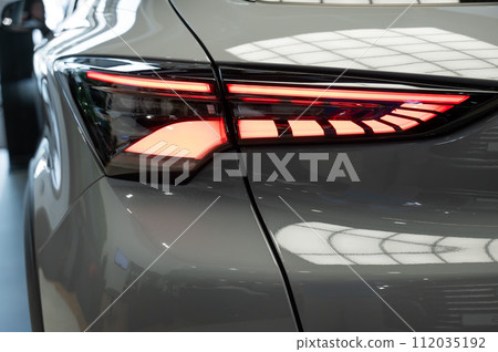 Close-up of the taillight of a white modern car. Close-up of the taillight of a white modern car. 112035192