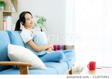 Young woman relaxing in the living room Young woman relaxing in the living room 112035861