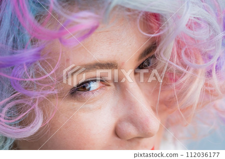 Cropped portrait of curly Caucasian woman with multi-colored hair. Model for hairstyles Cropped portrait of curly Caucasian woman with multi-colored hair. Model for hairstyles 112036177