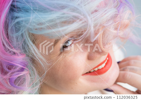 Close-up portrait of curly Caucasian woman with multi-colored hair. Model for hairstyles 112036325