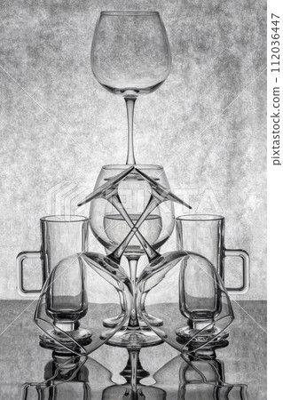 Still life with glassware on a reflective surface 112036447
