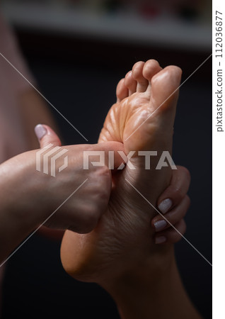 Close-up of a woman's foot massage. Vertical photo. Close-up of a woman's foot massage. Vertical photo. 112036877