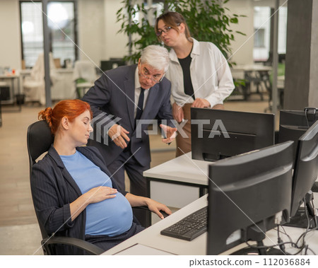 A pregnant woman sleeps at her workplace. Colleagues are indignant. A pregnant woman sleeps at her workplace. Colleagues are indignant. 112036884