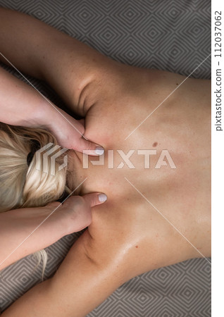 Top view of a woman undergoing a cervical-neck massage. Vertical photo. Top view of a woman undergoing a cervical-neck massage. Vertical photo. 112037062