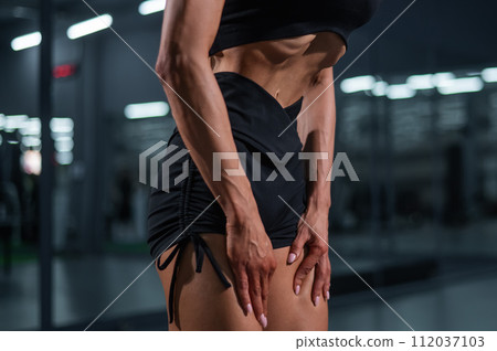 Faceless woman doing vacuum exercise in the gym. Faceless woman doing vacuum exercise in the gym. 112037103