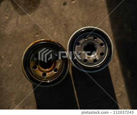 Old and new car oil filter. No people.  112037243