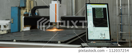 CNC machine. Laser cutting of metal. Sparks. 112037254