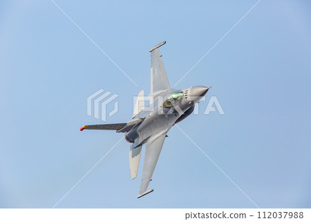 F-16 fighter jet flying in the blue sky F-16 fighter jet flying in the blue sky 112037988