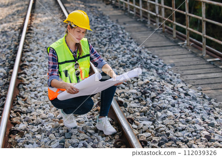 Engineer railway tracks construction service team working on site survey checking and maintenance inspection train track for safety Engineer railway tracks construction service team working on site survey checking and maintenance inspection train track for safety 112039326
