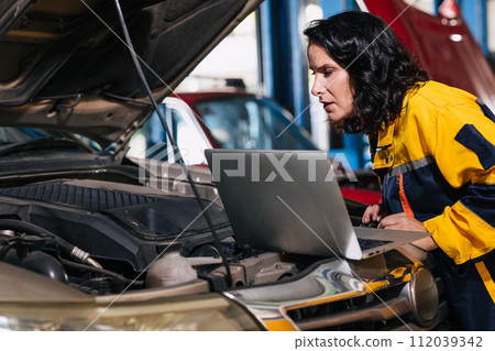 auto mechanic car engineer using laptop computer tuning ECU diagnosis analysis monitor engine problem in garage auto service 112039342