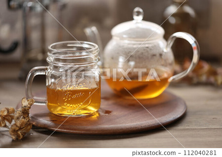 Rooibos tea in a glass teapot and a glass mug Rooibos tea in a glass teapot and a glass mug 112040281