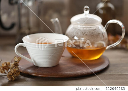 Rooibos tea in a glass teapot and a teacup Rooibos tea in a glass teapot and a teacup 112040283