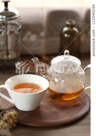 Rooibos tea in a glass teapot and a teacup Rooibos tea in a glass teapot and a teacup 112040284