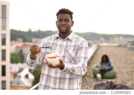 Male in casual shirt, with fork in hand and vegetable salad in bowl. Male in casual shirt, with fork in hand and vegetable salad in bowl. 112040301